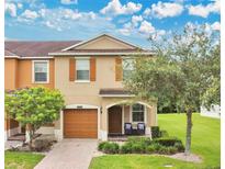 Charming two-story home with a well-maintained front yard, covered entrance, and attached garage at 10656 Savannah Plantation Ct, Orlando, FL 32832