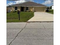 Charming single story home featuring a well-maintained lawn and a two-car garage at 107 Athabasca Dr, Poinciana, FL 34759
