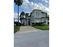 Stunning two-story home with meticulously maintained landscaping and a large driveway at 160 Calabay Parc Blvd, Davenport, FL 33897