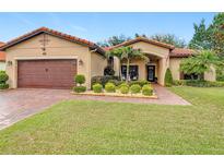 Charming one-story home with a well-manicured lawn, tile roof, and inviting front entrance at 169 Verde Way, Debary, FL 32713