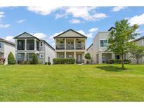 Charming two-story home featuring a well-maintained lawn and inviting double balconies at 1787 White Feather Loop, Oakland, FL 34787
