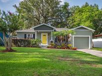 Charming single-story home with a well-manicured lawn and colorful front yard landscaping at 2100 Forest Cir, Orlando, FL 32803
