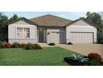 Charming single-story home showcasing well-manicured landscaping and a two-car garage at 3136 Firethorn Cir, Daytona Beach, FL 32124