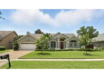 Charming single-story home with a well-manicured lawn and a two-car garage at 3618 Rothbury Dr, Belle Isle, FL 32812