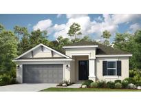 Charming single-story home featuring a two-car garage, neutral stucco, and a welcoming front entrance at 561 Moon Shell Cir, New Smyrna Beach, FL 32168