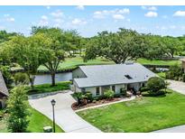 Beautiful home with mature trees, well-manicured lawn and landscaping on a beautiful lot with golf course views at 6836 Bittersweet Ln, Orlando, FL 32819