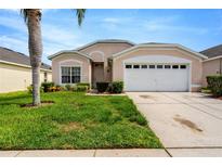 Charming single-Gathering home featuring a manicured front lawn and a two-car garage at 8152 Fan Palm Way, Kissimmee, FL 34747