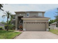 Charming two-story home with a spacious two-car garage and professionally landscaped yard at 8206 Gemstone Ct, Orlando, FL 32836