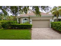 Charming single-Gathering home featuring a two-car garage and a well-manicured lawn and mature landscaping at 8108 Via Bella Notte, Orlando, FL 32836