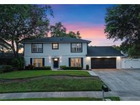 Charming two-story home with a well-manicured lawn and inviting curb appeal against a colorful dusk sky at 1105 Appleton Ave, Orlando, FL 32806