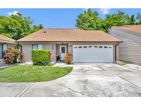 Charming single-story home with attached garage, well-kept lawn, and inviting curb appeal at 1117 Park Green Pl, Winter Park, FL 32789