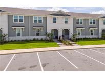 Inviting townhome with well-manicured lawn and convenient parking at 1292 Blue Island Dr, Clermont, FL 34714