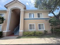 Charming condo building exterior with manicured landscaping and visible unit number at 13207 Villa Vista Dr # 205, Orlando, FL 32824