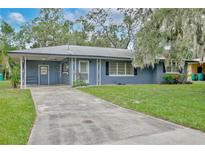 Charming single-story home with a well-maintained lawn and a long driveway at 1607 Lindale Ave, Eustis, FL 32726