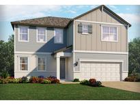 Charming two-story home featuring mixed siding, a two-car garage, and a professionally landscaped front yard at 3113 Legends Preserve Dr, Daytona Beach, FL 32124