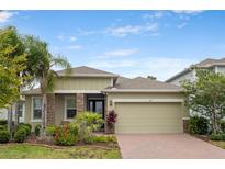 Charming single-story home boasts stone accents, lush landscaping, and a brick driveway for added curb appeal at 363 Miro Dr, Davenport, FL 33837