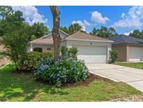 Charming single-story home featuring a well-manicured lawn and beautiful landscaping at 369 Placid Lake Dr, Sanford, FL 32773