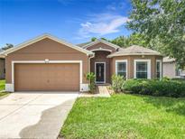 Charming single-story home featuring a two-car garage, well-maintained lawn, and inviting curb appeal at 5431 Lochdale Dr, Orlando, FL 32818