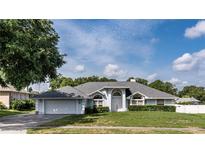 Charming single-story home with a well-manicured lawn and inviting curb appeal in a residential neighborhood at 9108 N Bay Boulevard, Orlando, FL 32819