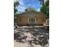 Modest yellow single-story home with symmetrical facade and a front parking area at 1218 37Th St, Orlando, FL 32805