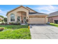 Charming single-Gathering home featuring a well-manicured lawn, attached two-car garage, and inviting front entrance at 14654 Lady Victoria Blvd, Orlando, FL 32826