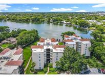 Beautiful lakefront condo building with lush green landscaping and stunning views from every unit at 204 Quayside Cir # 601, Maitland, FL 32751