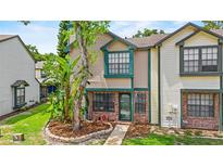 Inviting two-story townhouse with manicured landscaping and a brick facade at 2930 Candela Ct, Apopka, FL 32703