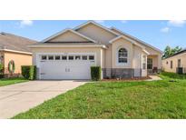 Charming single-story home with a well-manicured lawn and attached two-car garage at 4533 Oakbrook Ct, Kissimmee, FL 34746