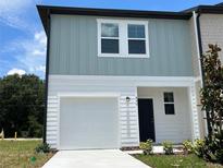Charming two-story townhome with a one-car garage, offering a blend of modern design and comfort at 477 Madison Dr, Davenport, FL 33837