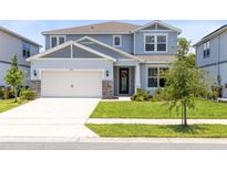 Charming two-story home with a well-manicured lawn and a two-car garage in a Gathering-friendly neighborhood at 5677 Cedar Chase Dr, St Cloud, FL 34771