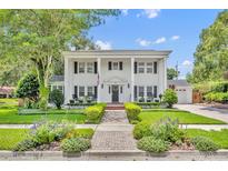 Classic colonial home featuring a manicured lawn, brick pathway, and stately white columns for curb appeal at 624 Richmond Street, Orlando, FL 32806