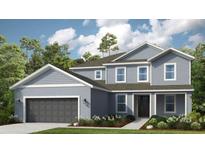 Charming two-story home with attached two-car garage, landscaped front yard, and a covered front entryway at 862 Junonia Blvd, New Smyrna Beach, FL 32168