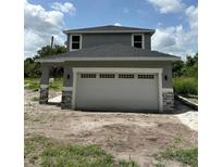 Two-story home featuring a two-car garage and stone veneer accents on the support columns at 1132 Morse St, Altamonte Springs, FL 32701