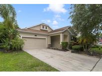 Charming single-Gathering home with a well-maintained lawn, attached garage, and inviting front entry at 13850 Amelia Pond Dr, Windermere, FL 34786