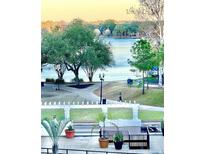 Scenic lake view featuring walking path, lush trees, and serene water at 151 E Washington St # 508, Orlando, FL 32801
