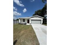 Charming single story home with a well manicured lawn and concrete driveway to a two car garage at 1754 35Th Nw St, Winter Haven, FL 33881