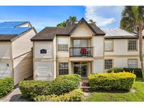 Charming two-story townhome with manicured landscaping and a cozy balcony, perfect for relaxing at 1924 Lake Atriums Cir # 52, Orlando, FL 32839