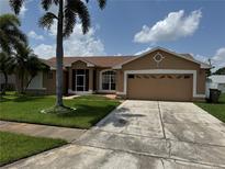 Charming single-story home with well-manicured lawn and mature palm tree at 2693 Maxwell W Ct, Kissimmee, FL 34743