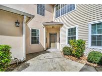 Inviting front entrance features a cozy covered porch and well-maintained landscaping at 3030 Clubview Dr # Ge, Orlando, FL 32822