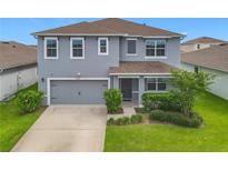 Charming two-story home featuring a gray exterior, well-maintained landscaping, and attached two-car garage at 3975 Silverstream Ter, Sanford, FL 32771