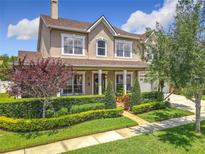Stunning two-story home featuring a manicured front lawn, lush landscaping, and a welcoming front porch at 4334 Tolkien St, Orlando, FL 32828