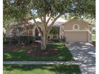 Charming single-story home with a well-maintained front yard and a two-car garage at 636 Cheviot Ct, Apopka, FL 32712