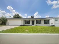 Charming single-story home with a well-manicured lawn, attached garage and a cozy front entrance at 7040 Hennepin Blvd, Orlando, FL 32818