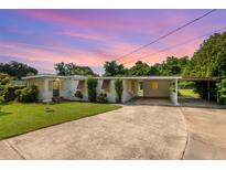Charming single-story home with a covered carport and well-maintained front yard at 7102 Easter St, Winter Park, FL 32792