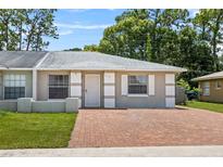 Charming single-story home featuring a well-maintained lawn and inviting brick driveway at 8116 Parrot Dr, Orlando, FL 32825