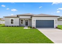 Charming single-story home with a well-manicured lawn and a two-car garage at 14905 Sw 39Th Cir, Ocala, FL 34473
