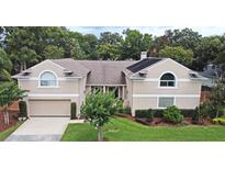 Charming two-story home featuring a well-manicured lawn and attached two car garage at 1653 Cheyenne Trl, Maitland, FL 32751