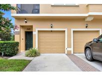 Close-up exterior shot of attached garages with a decorative front door entrance at 2011 Crestdale Ln, Lake Mary, FL 32746