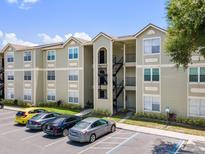 View of the condo complex featuring three-story buildings with balconies and parking at 2550 N Alafaya Trl # 9201, Orlando, FL 32826