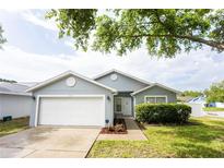 Charming single-story home featuring a two-car garage and a well-maintained front yard at 302 Cello Cir, Winter Springs, FL 32708